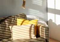 two white and yellow pillows on gray sofa