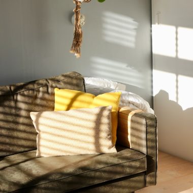 two white and yellow pillows on gray sofa