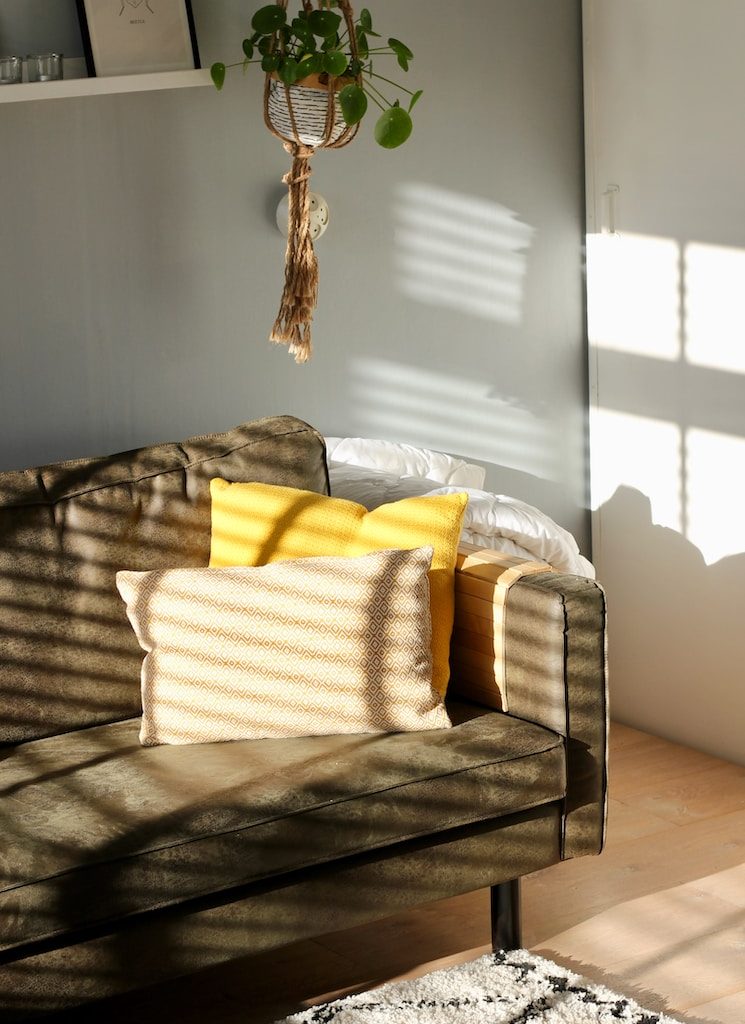 two white and yellow pillows on gray sofa