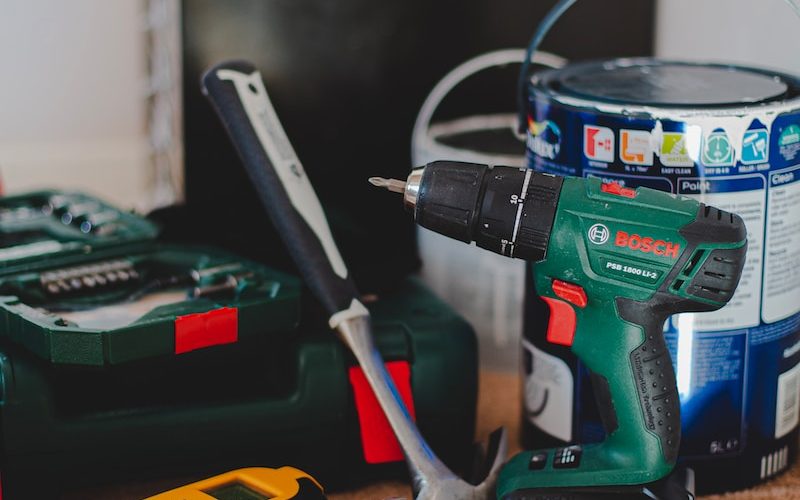 red and black cordless power drill beside black and red cordless power drill