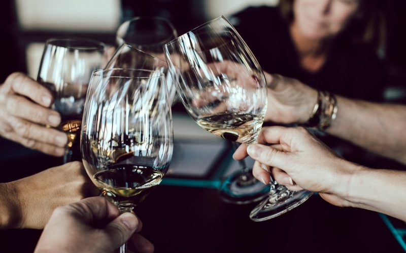 group of people holding footed glasses