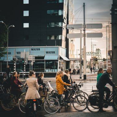 men and women riding on bikes on road