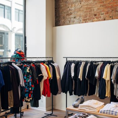 assorted-color clothes hanging on metal racks