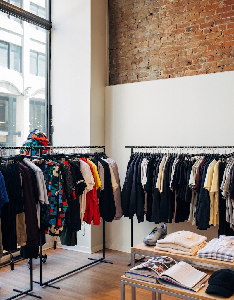 assorted-color clothes hanging on metal racks