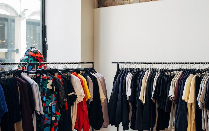 assorted-color clothes hanging on metal racks