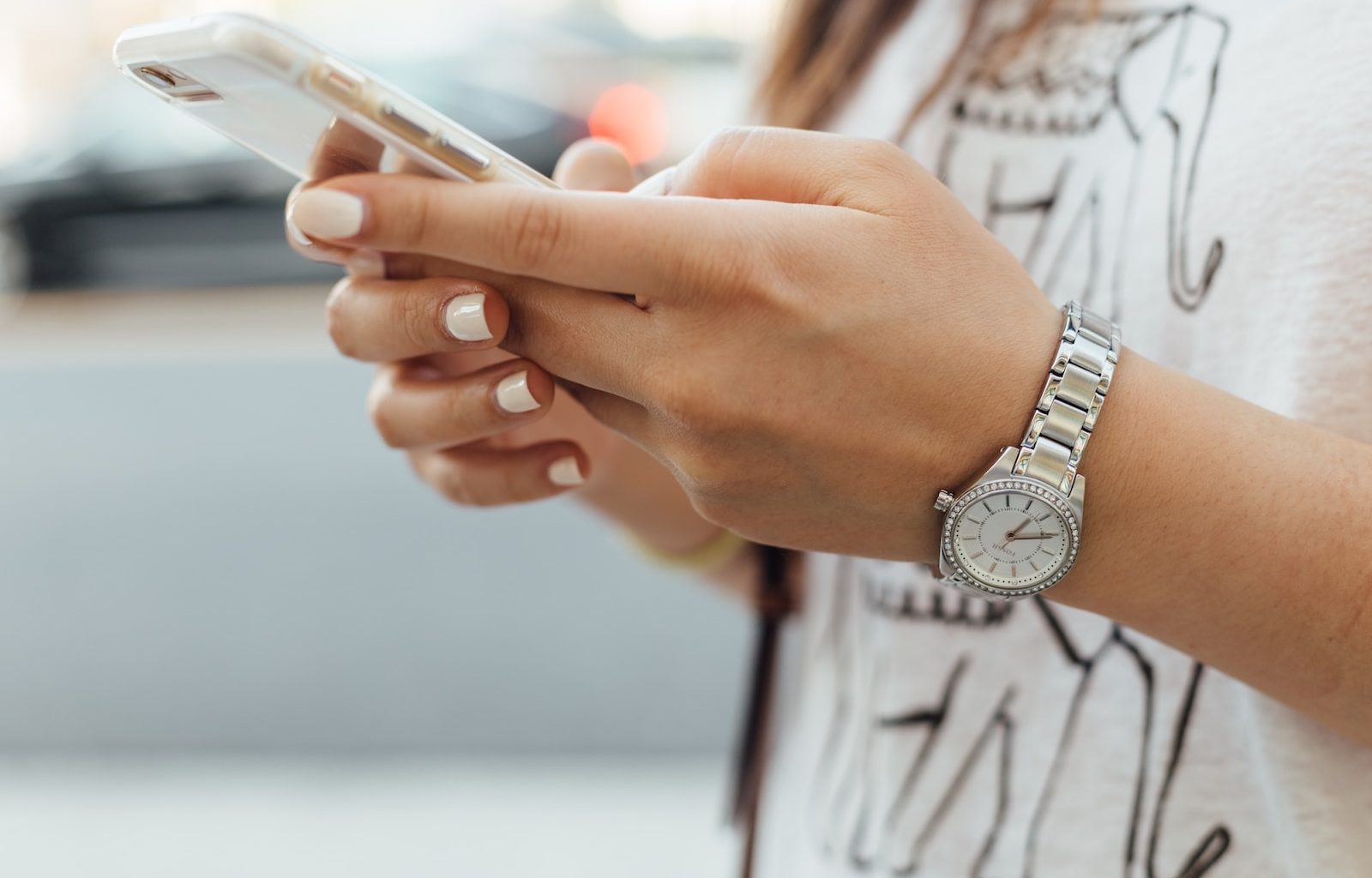 woman holding iPhone during daytime