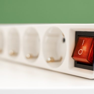 a close up of a red light on a white device