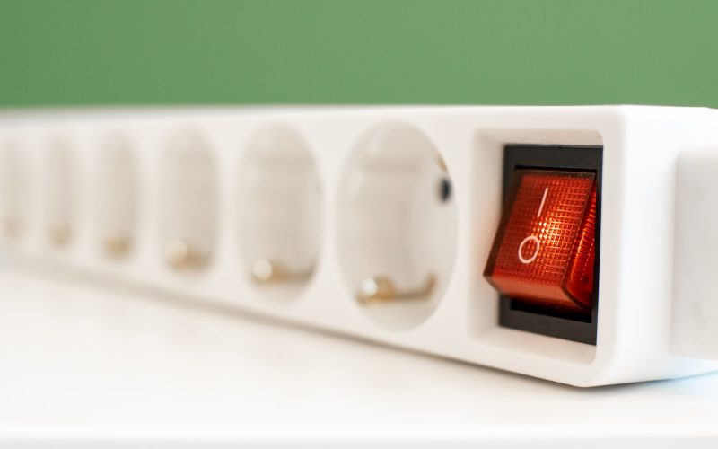 a close up of a red light on a white device