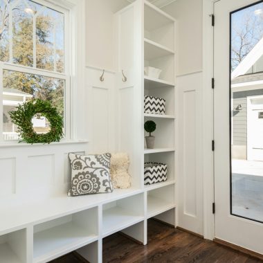 gray and white floral throw pillow beside rack inside room