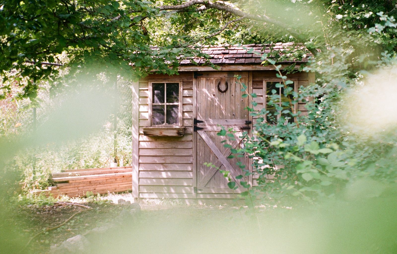 focus photography of brown wooden shed