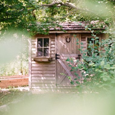 focus photography of brown wooden shed