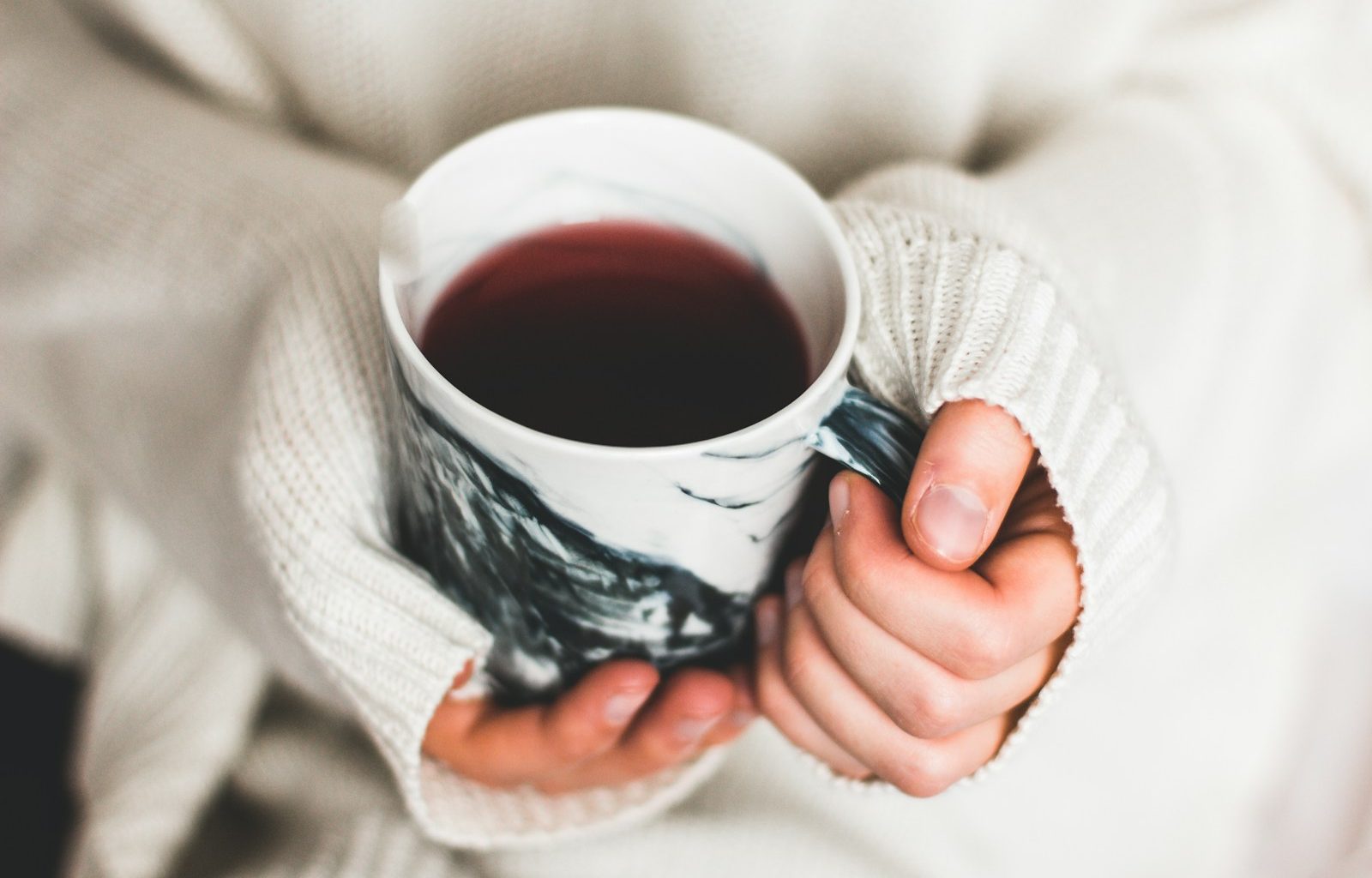 person holding cup of coffee