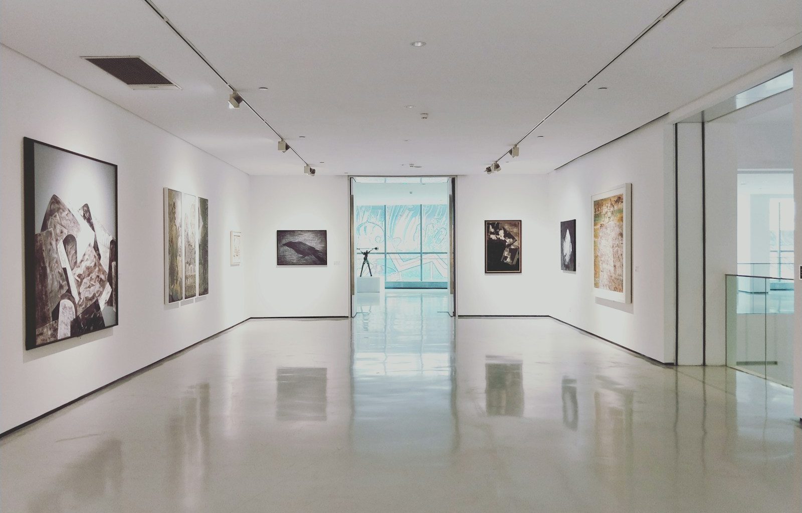 assorted paintings on white painted wall