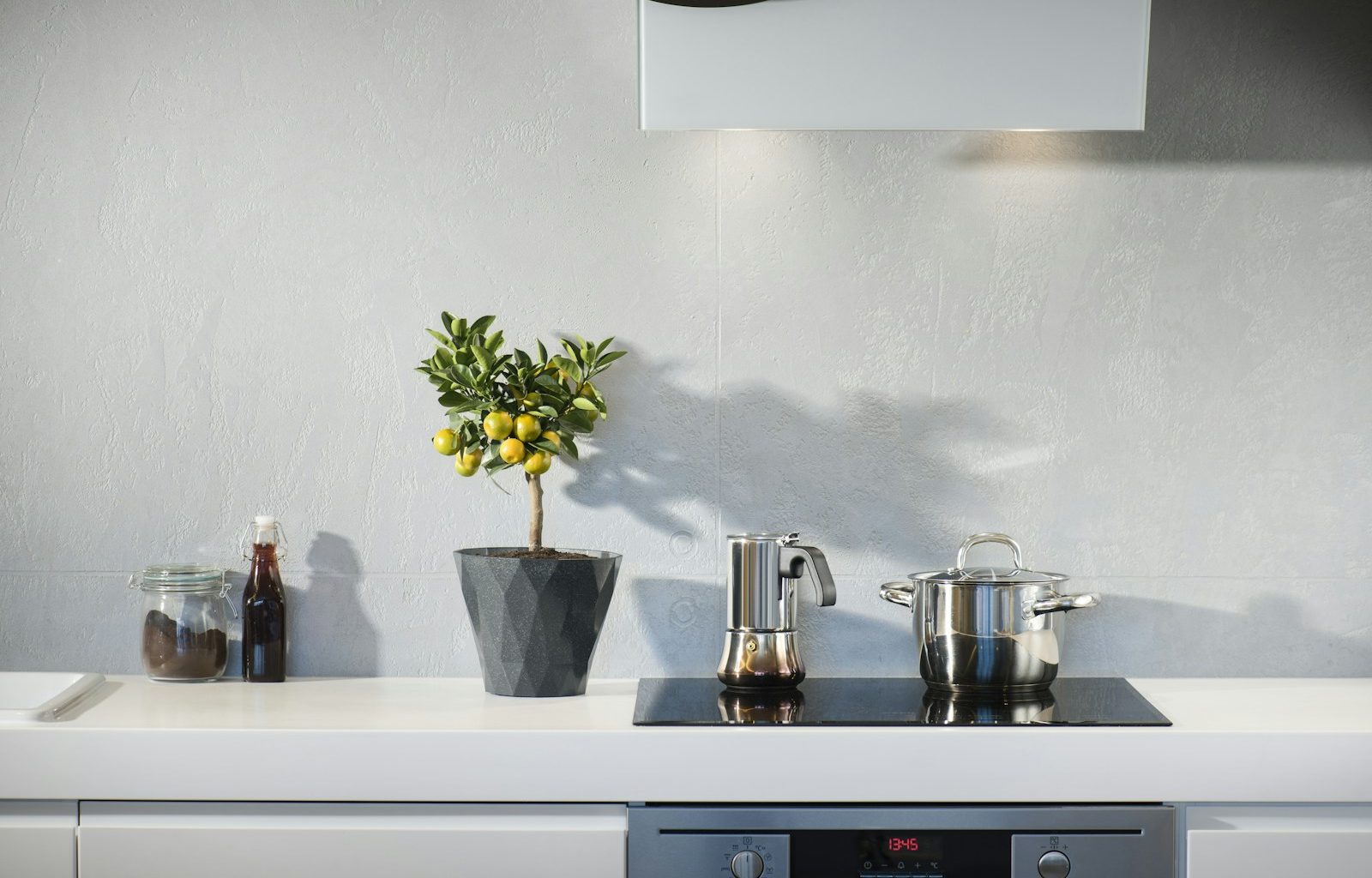 silver pot on top of induction oven