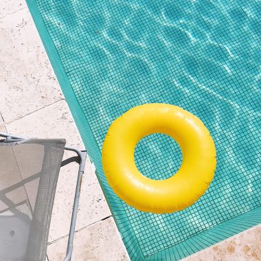 yellow plastic round toy on green table