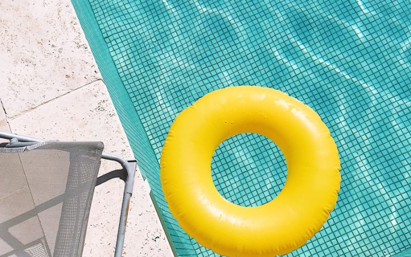 yellow plastic round toy on green table