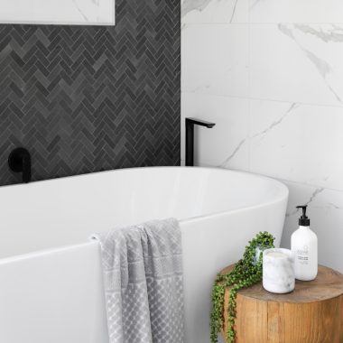 white bathtub near white ceramic bathtub