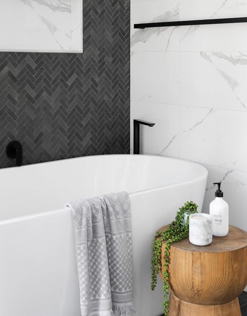 white bathtub near white ceramic bathtub