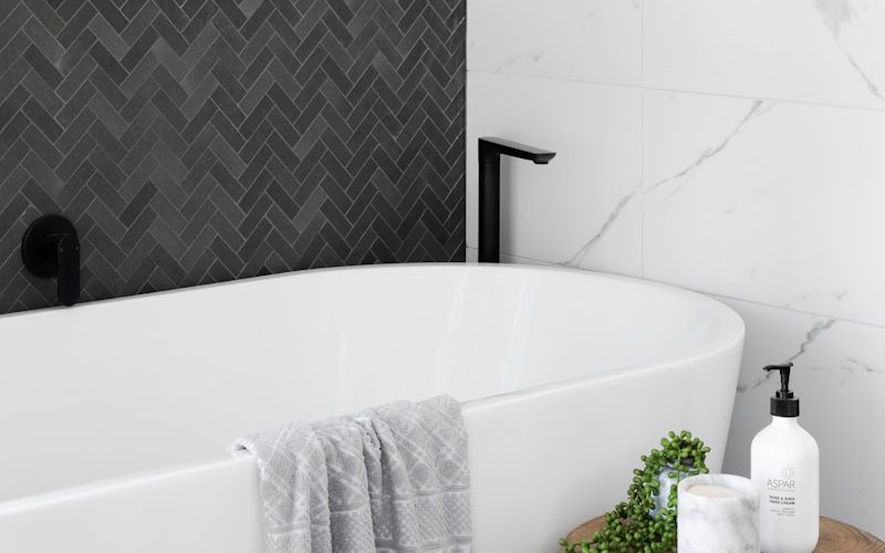 white bathtub near white ceramic bathtub