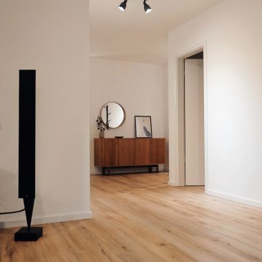 black tower speaker beside white wall