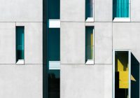 a building with multiple windows and a yellow door