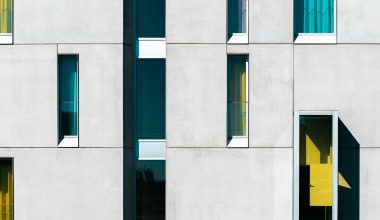 a building with multiple windows and a yellow door