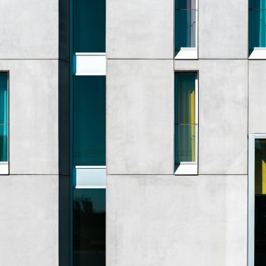 a building with multiple windows and a yellow door