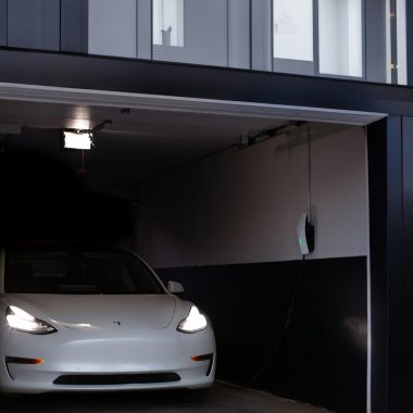 a white car is parked in a garage