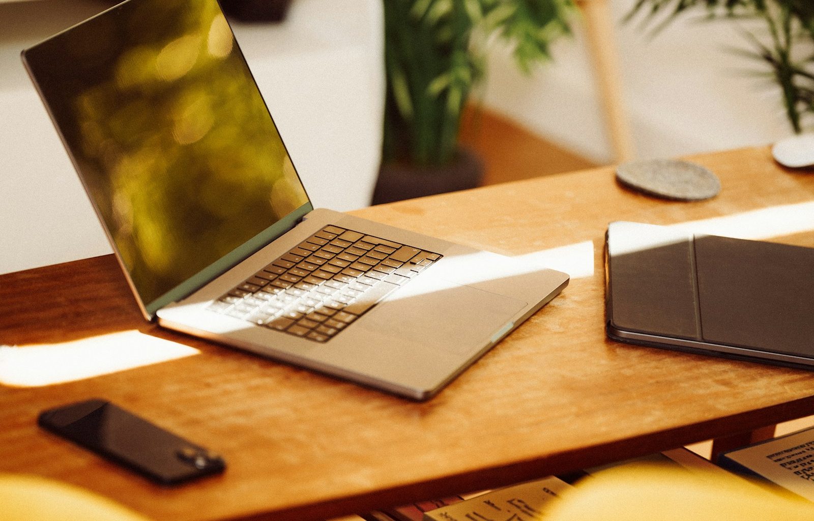 A laptop computer sitting on top of a wooden desk